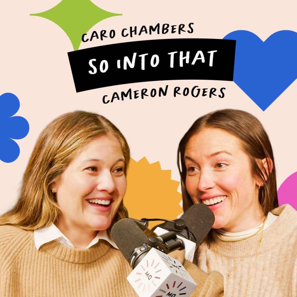 Two women in beige sweaters speak into microphones against a colorful background with text reading "Caro Chambers, So Into That, Cameron Rogers.